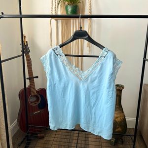 Blue top, lace trim.